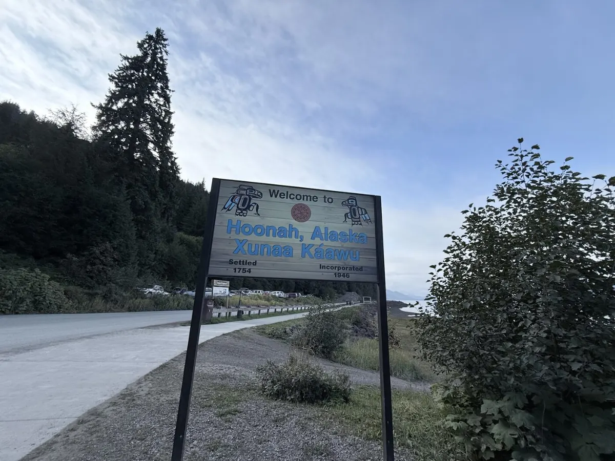 The Welcome to Hoonah, Alaska Xunaa Kaawu road sign marking the entrance to town